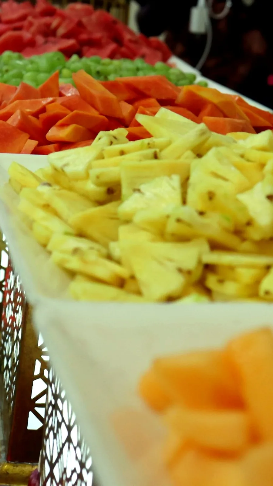 Live cut fruit counter with pineapple, papaya, kiwi and watermelon at a Chennai wedding reception
